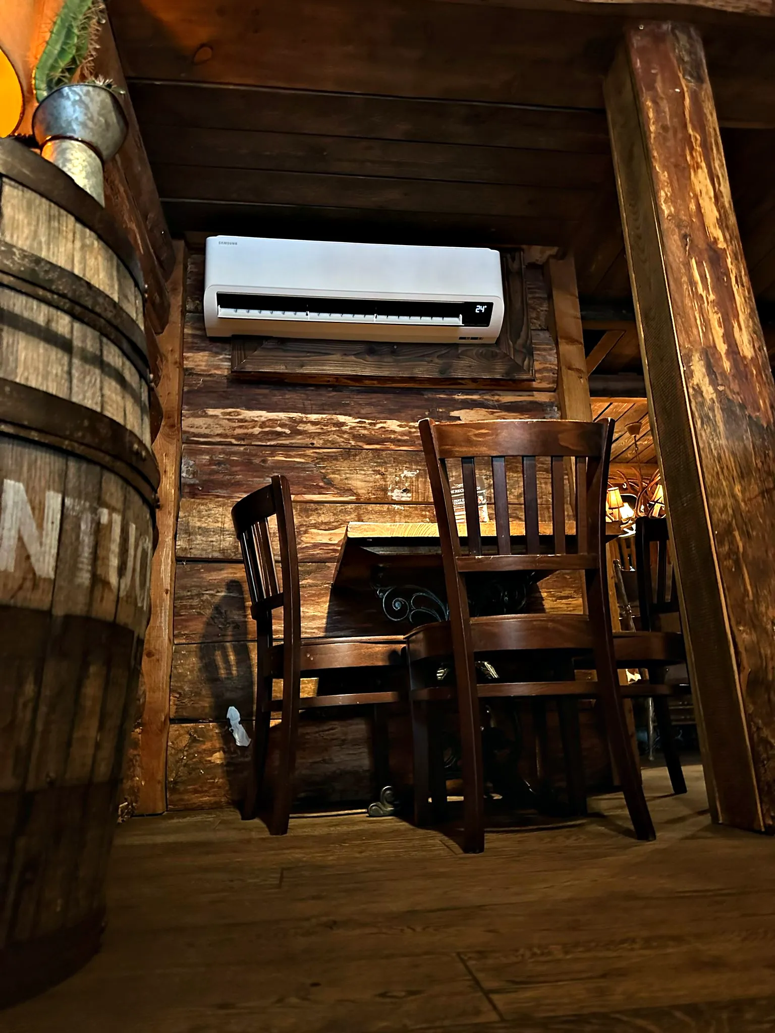 A wall unit above the booths of a bar with timber panelling