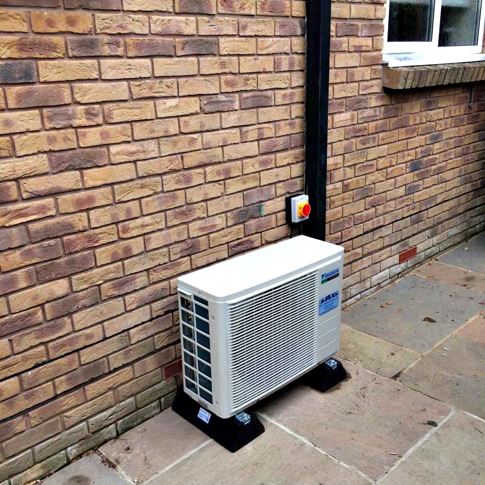 A Daikin outdoor unit on a stone patio