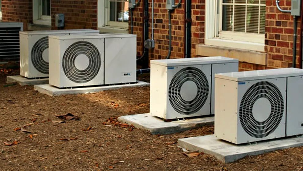 Two outdoor units side by side in a garden