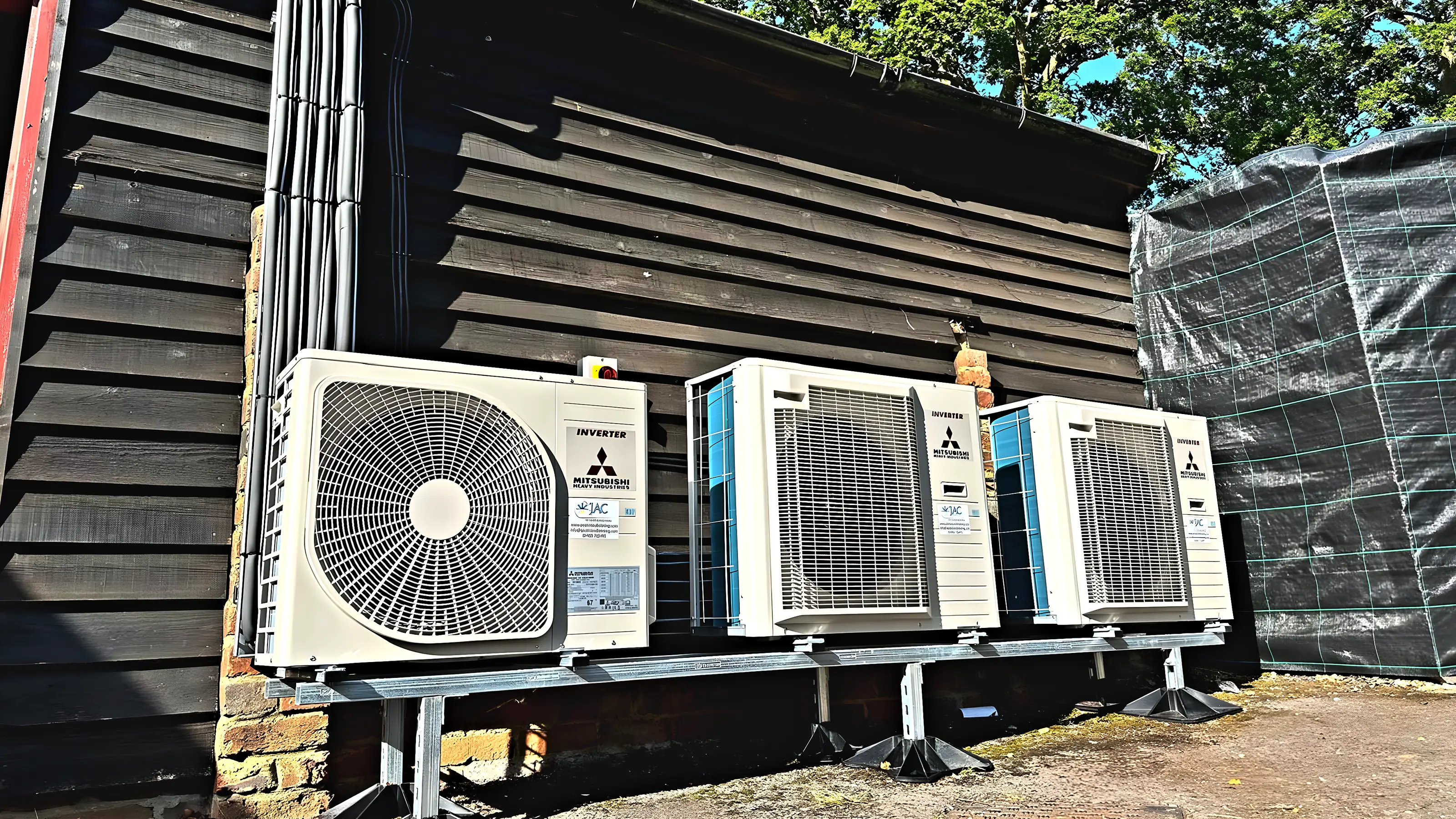 A bank of Mitsubishi Heavy Industries outdoor units on a weatherboarded wall