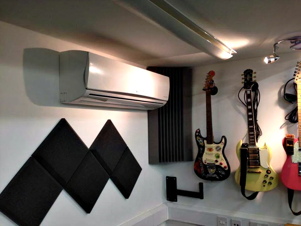 A wall mounted unit in a music room with acoustic panels