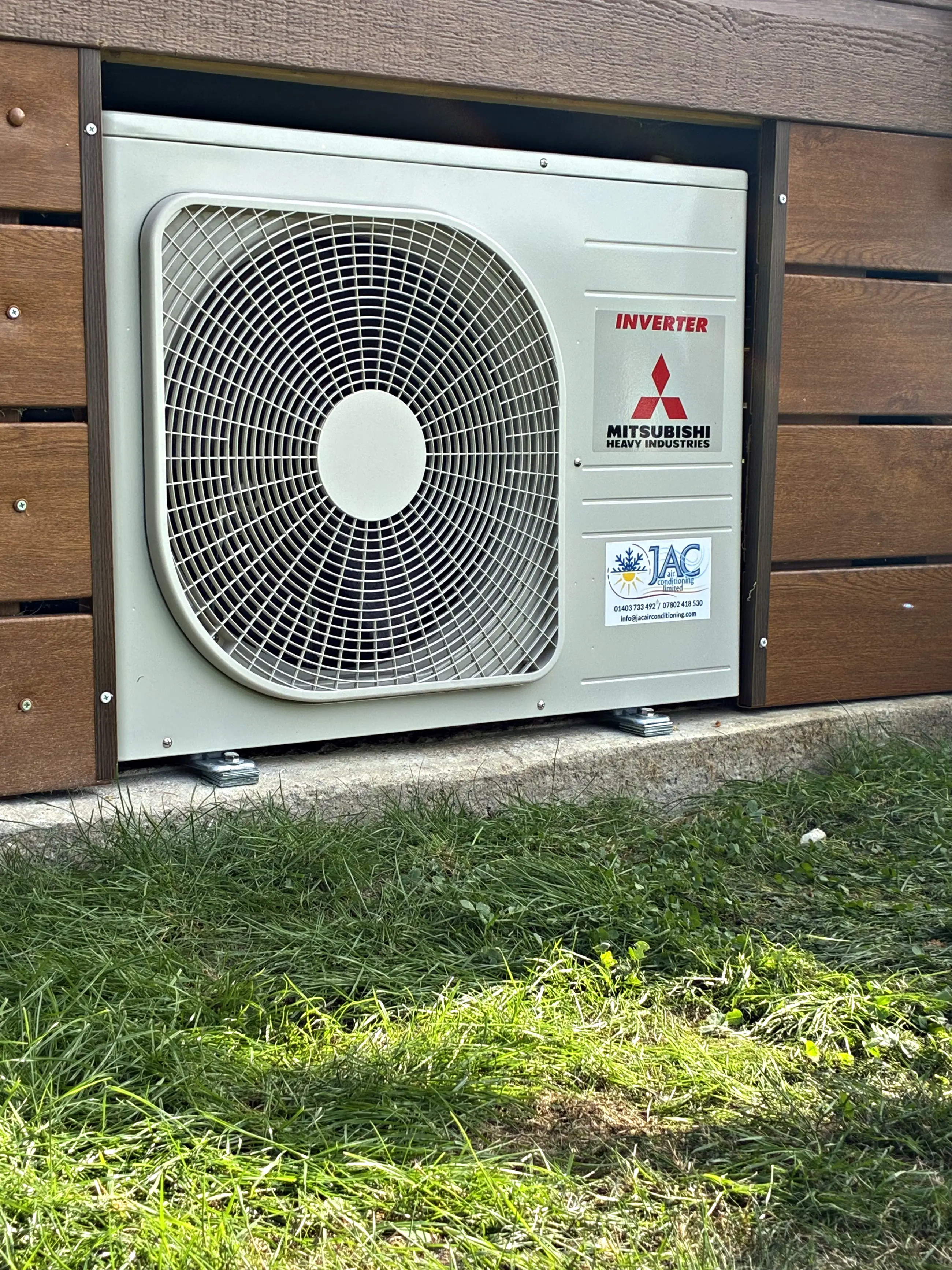 A Mitsubishi Heavy Industries outdoor unit set into the timber skirting of a park home