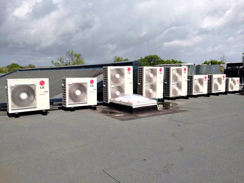 Commercial outdoor units in a row on a flat roof